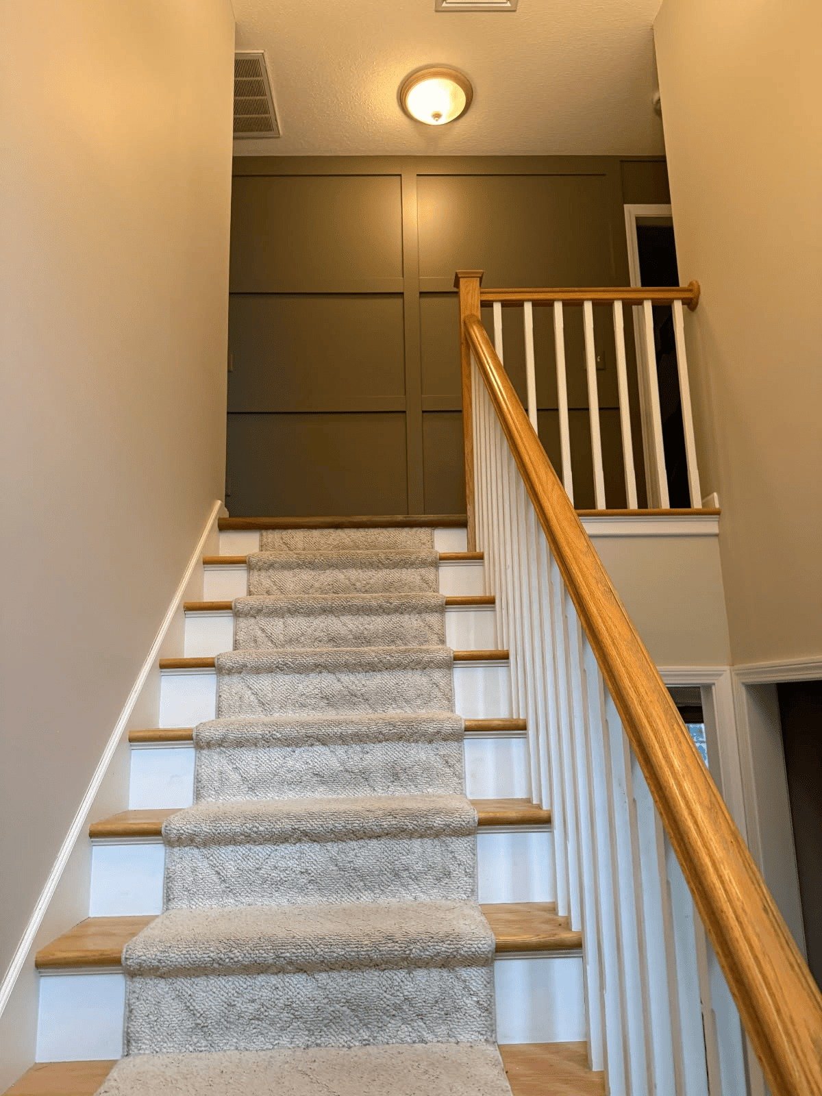Stairwell with a freshly painted accent wall and white trim