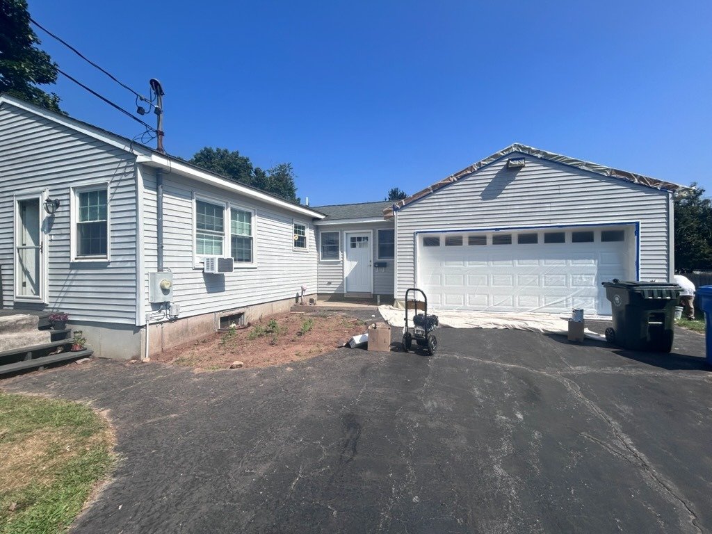 Light gray sided house after exterior prep and washing
